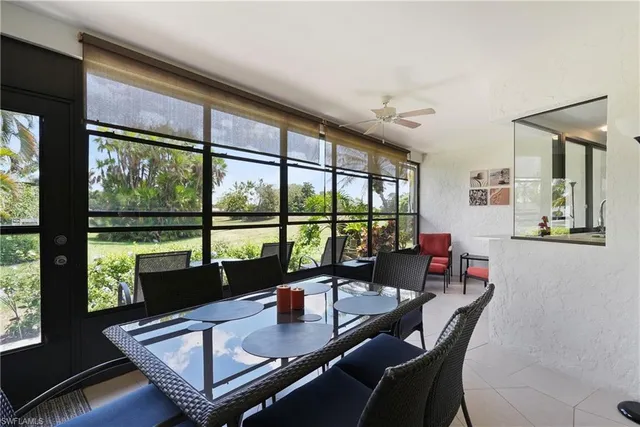 a view of a dining room with furniture large windows and wooden floor