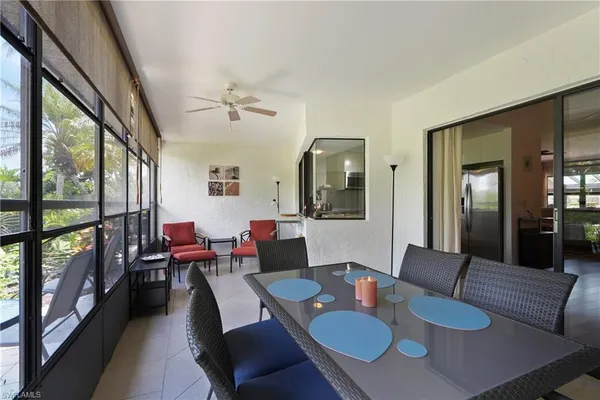 a view of a dining room with furniture a rug and wooden floor