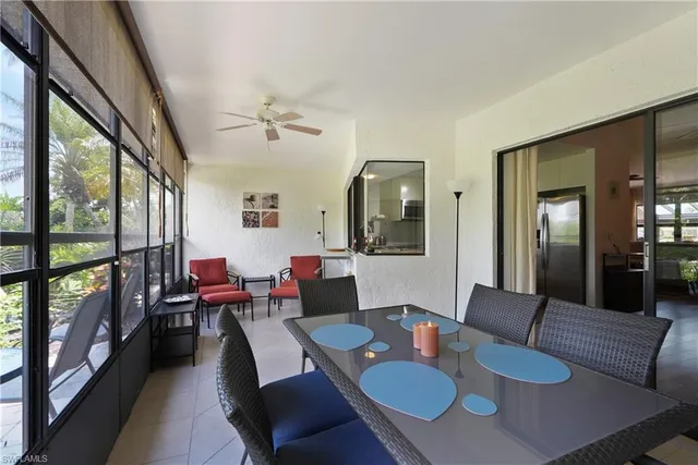 a view of a dining room with furniture a rug and wooden floor