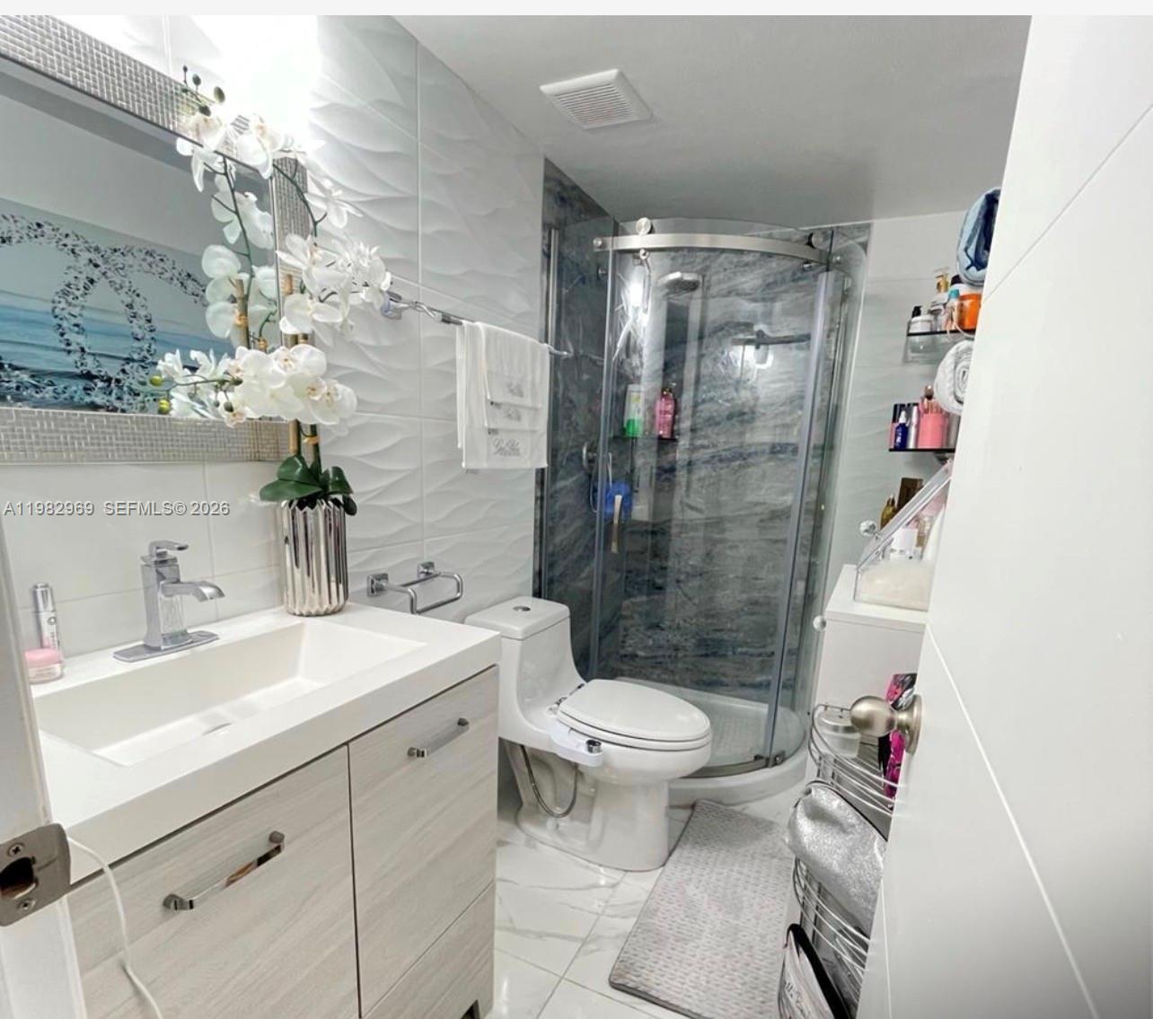 2641 North Flamingo Road, Unit 1505N Sunrise, FL 33323 - Photo 12 of 13 a bathroom with a sink toilet and shower
