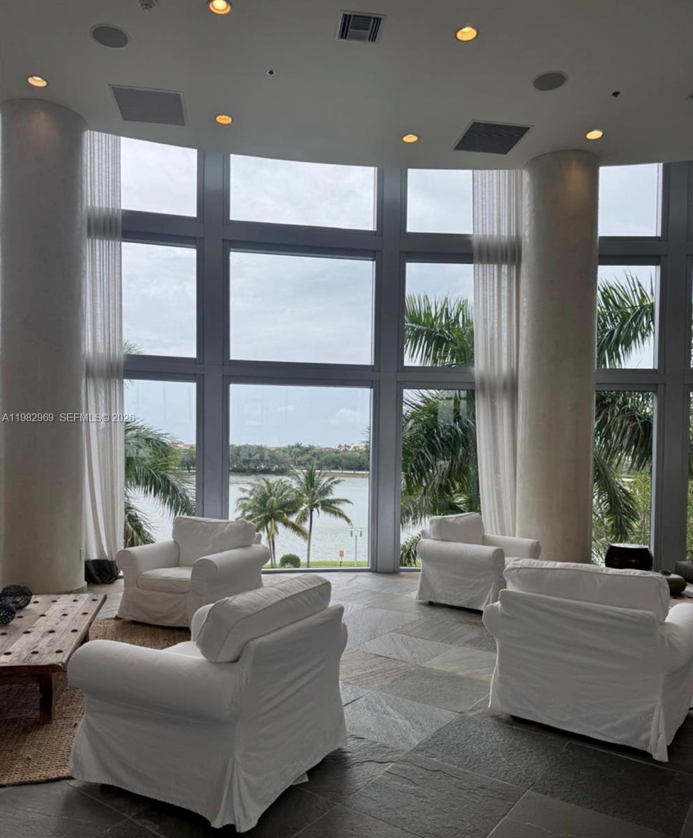 2641 North Flamingo Road, Unit 1505N Sunrise, FL 33323 - Photo 2 of 13 a living room with furniture and large windows