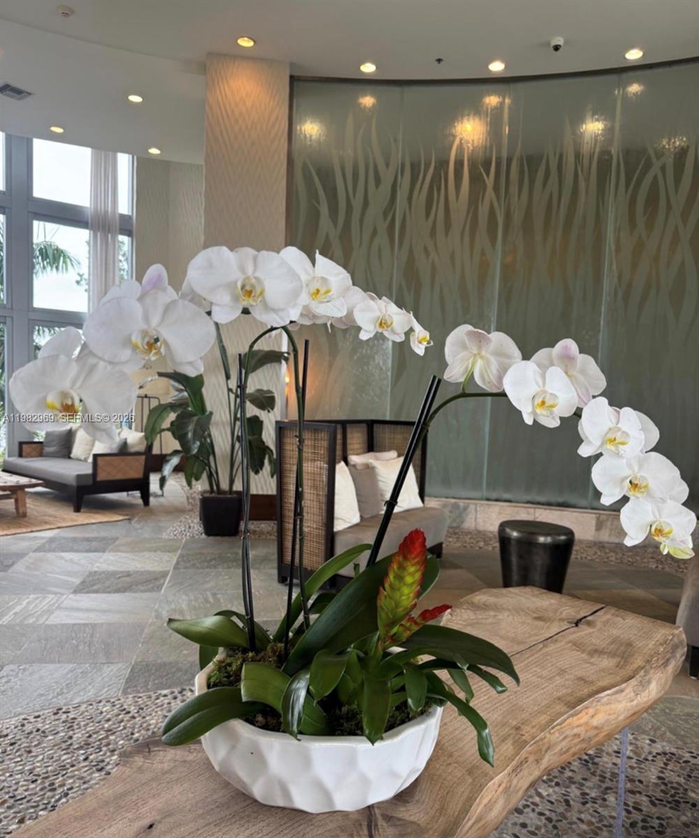 2641 North Flamingo Road, Unit 1505N Sunrise, FL 33323 - Photo 3 of 13 a dining room filled with lots of potted plants