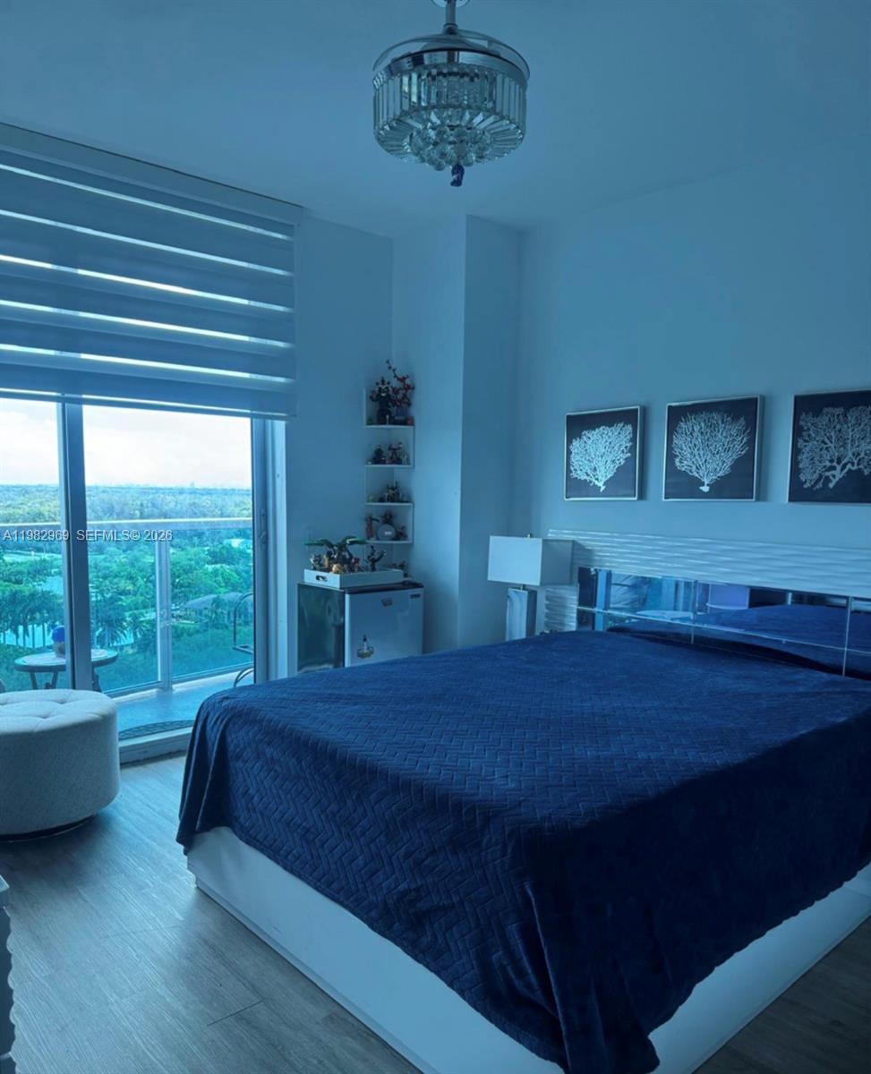 2641 North Flamingo Road, Unit 1505N Sunrise, FL 33323 - Photo 6 of 13 a bed sitting in a bedroom next to a window
