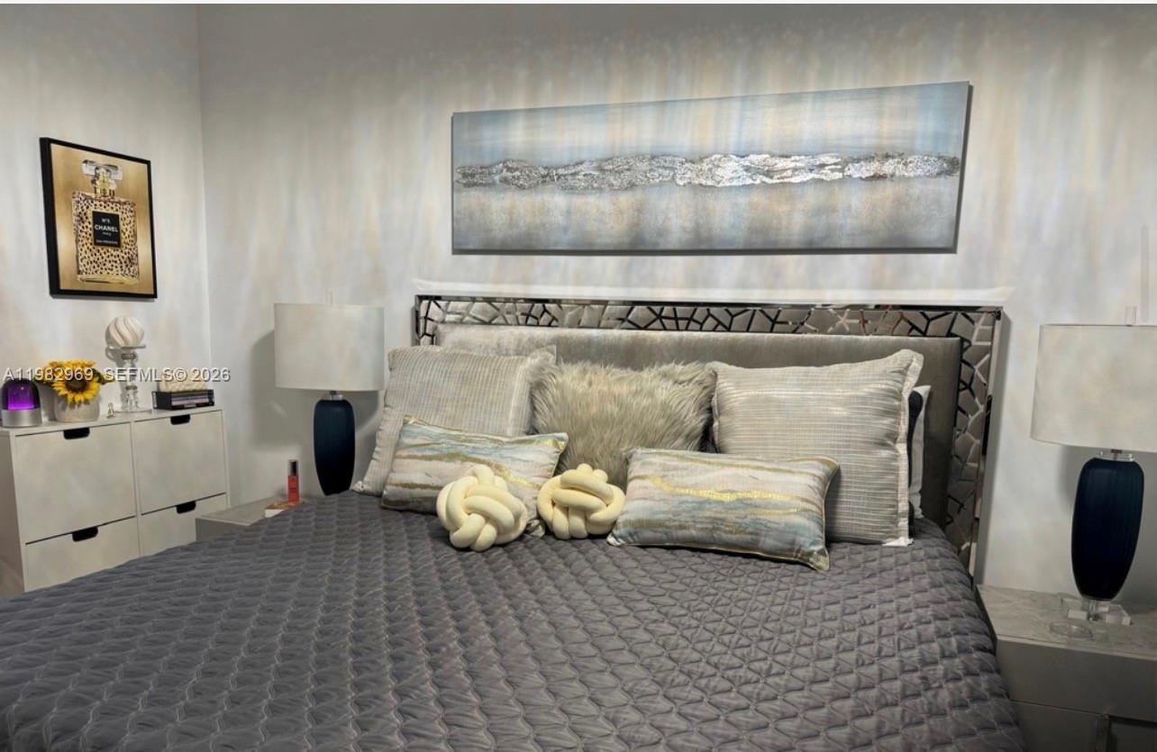 2641 North Flamingo Road, Unit 1505N Sunrise, FL 33323 - Photo 8 of 13 a living room with furniture and a table