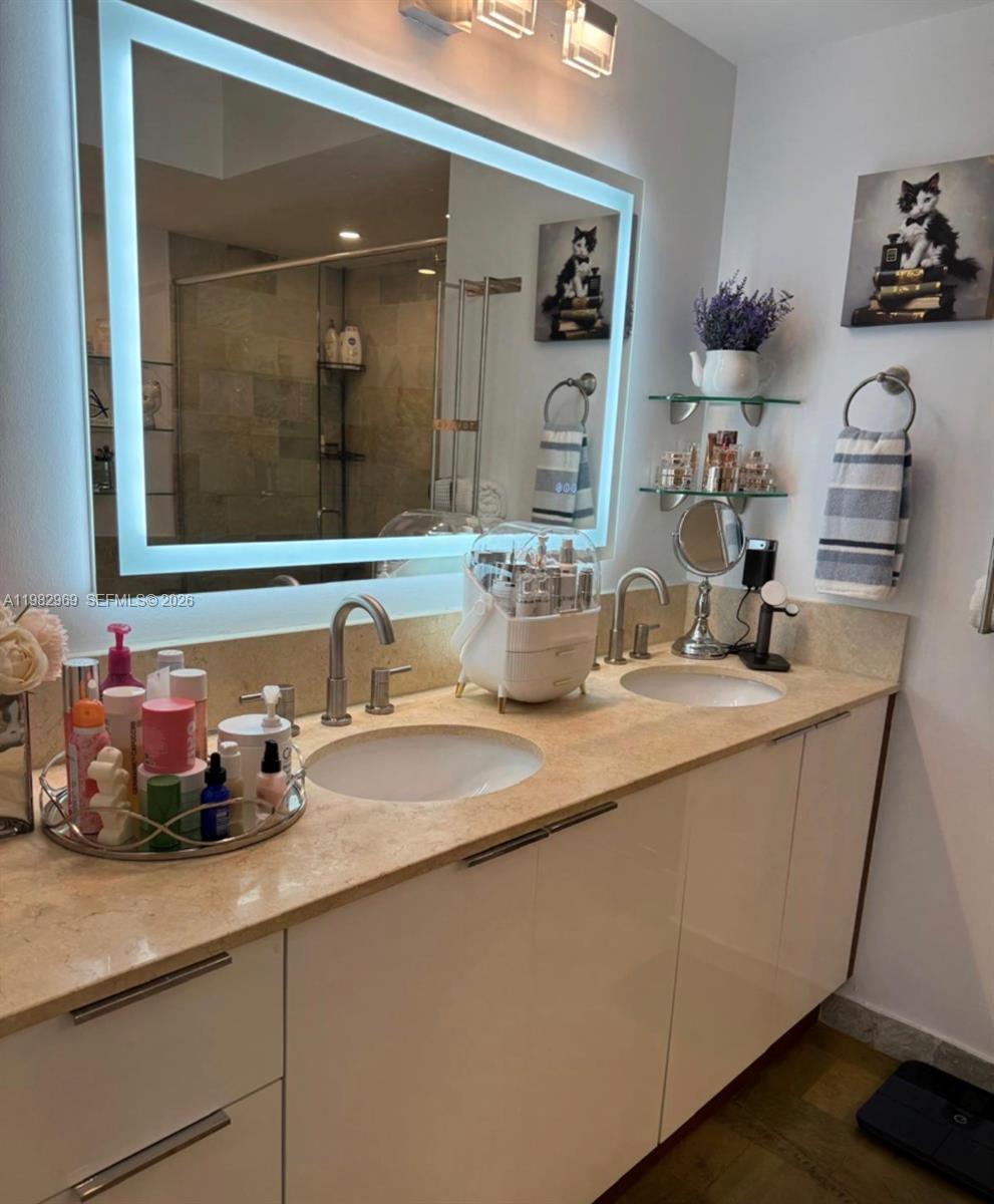 2641 North Flamingo Road, Unit 1505N Sunrise, FL 33323 - Photo 9 of 13 a bathroom with a sink and a mirror