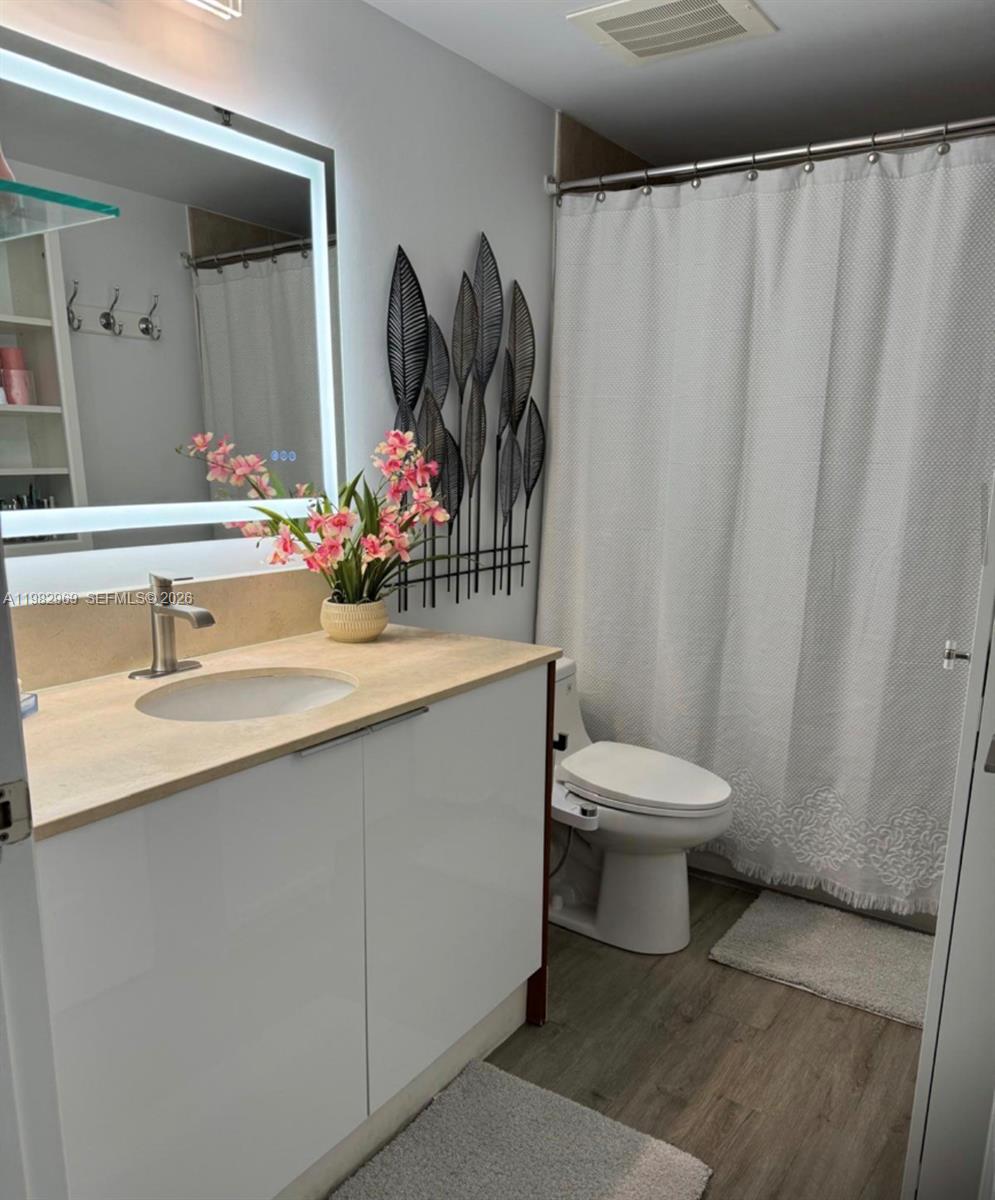 2641 North Flamingo Road, Unit 1505N Sunrise, FL 33323 - Photo 10 of 13 a bathroom with a sink toilet and shower