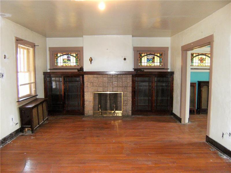 316 Le Roi Road Pittsburgh, PA 15208 - Photo 3 of 24 Living Room With 4 Stained Glass Windows, Fireplace Glass Door Built-Ins And Hardwood Floor