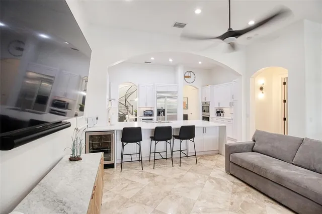 a kitchen with a dining table chairs and white cabinets