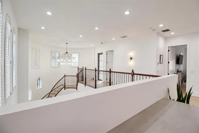 a spacious bedroom with a bed and a wooden floor