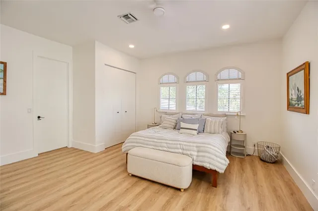 a spacious bedroom with two beds and a couch