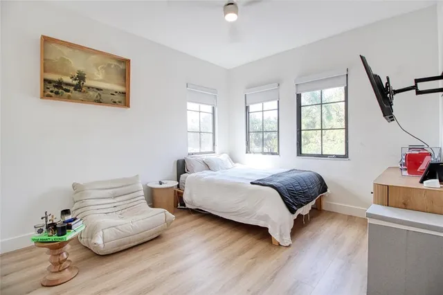 a bedroom with a bed and a window