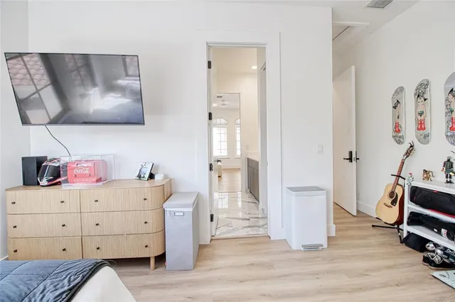 a bedroom with a bed and a television