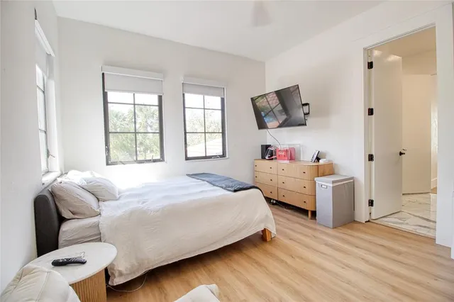 a bedroom with a bed and a flat screen tv