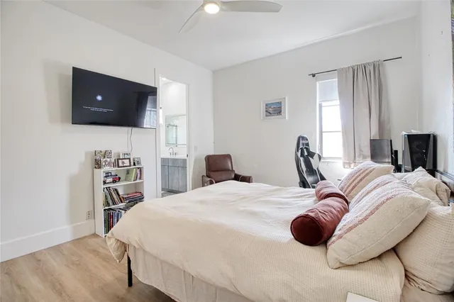 a bedroom with a bed and a flat screen tv