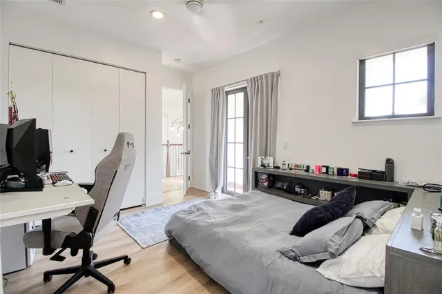 a view of a swimming pool with lawn chairs and couches