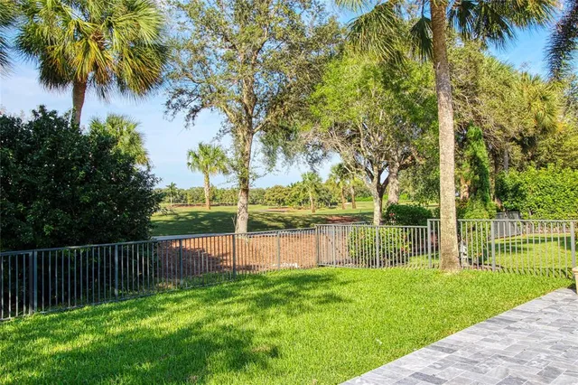 an aerial view of a city with lots of residential buildings lake and mountain view in back