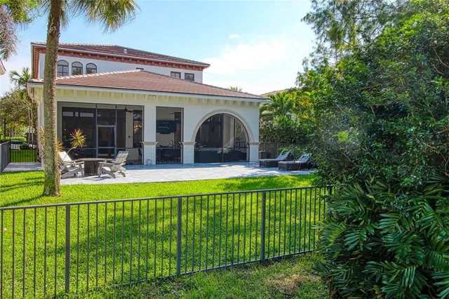 an aerial view of a house with outdoor space and lake view
