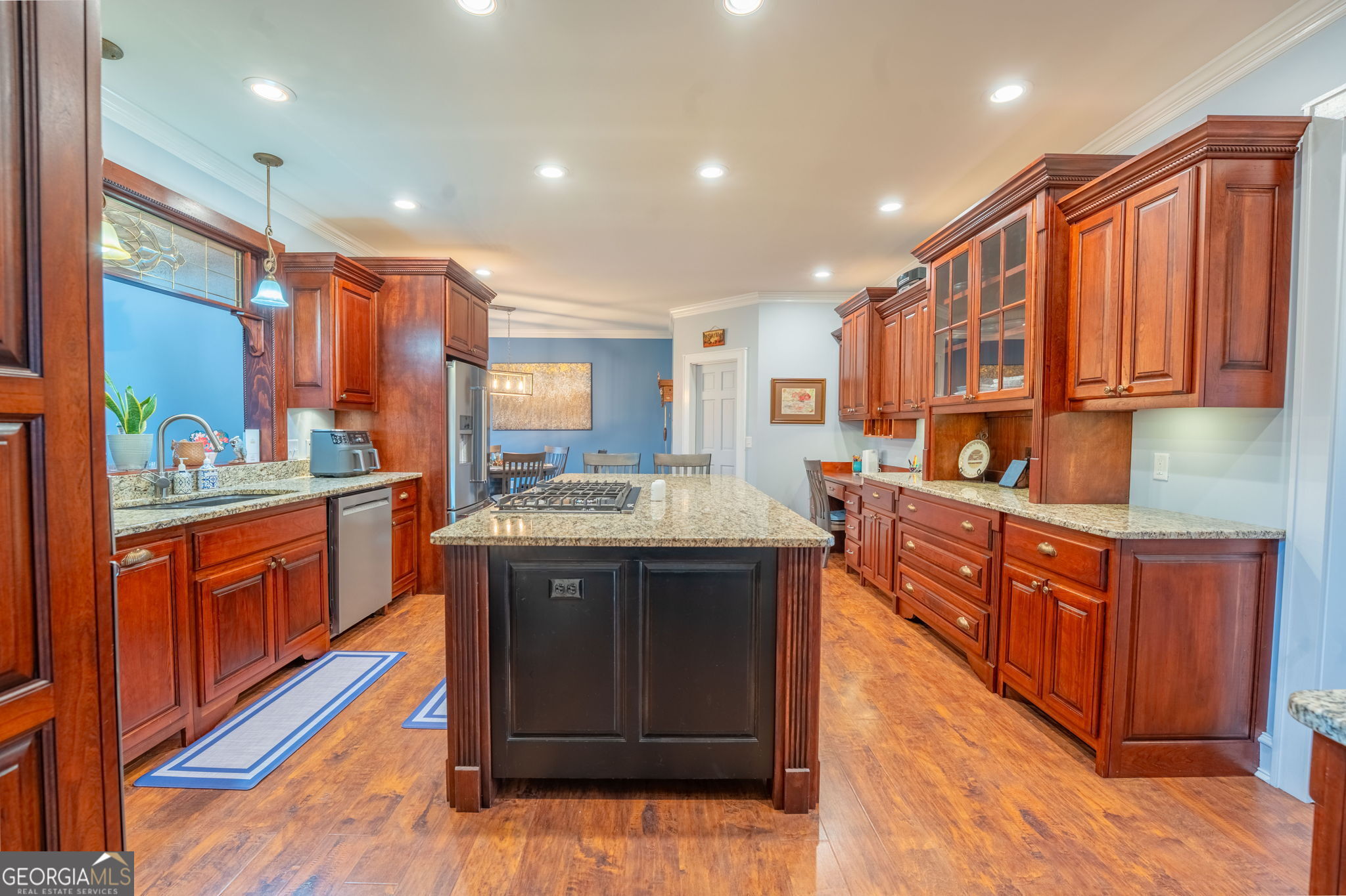 712 Meadow Run Court Clarkesville, GA 30523 - Photo 45 of 96 a kitchen with stainless steel appliances granite countertop wooden cabinets a sink and dishwasher a stove with wooden floor