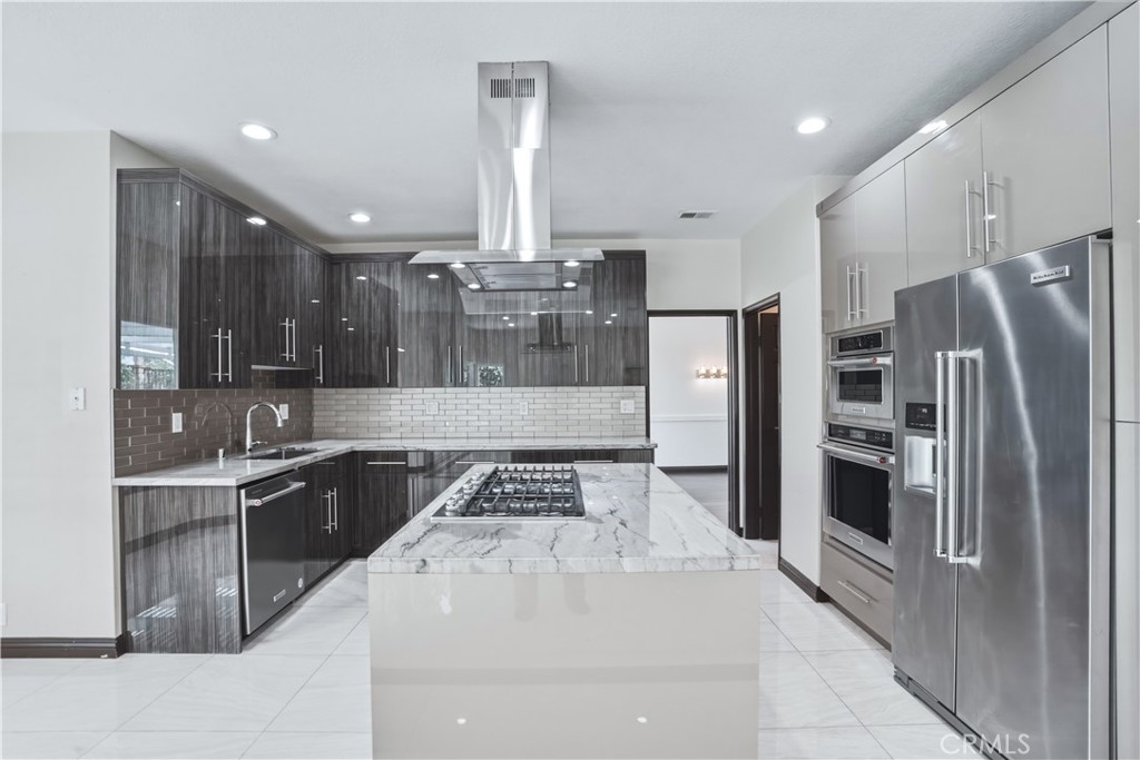 3537 Foxglove Road Glendale, CA 91206 - Photo 32 of 73 a kitchen with stainless steel appliances granite countertop a sink a stove and a refrigerator