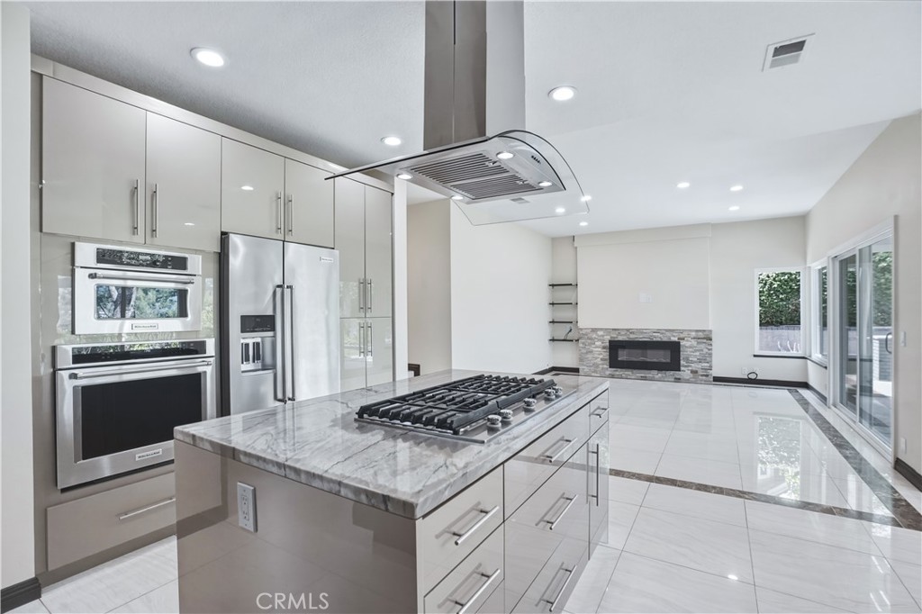 3537 Foxglove Road Glendale, CA 91206 - Photo 36 of 73 a kitchen with stainless steel appliances granite countertop a stove and a refrigerator