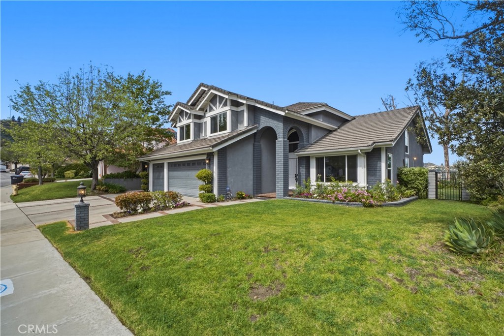3537 Foxglove Road Glendale, CA 91206 - Photo 4 of 73 a front view of a house with a garden and trees