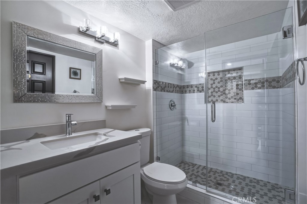 3537 Foxglove Road Glendale, CA 91206 - Photo 51 of 73 a bathroom with a sink toilet a mirror and shower