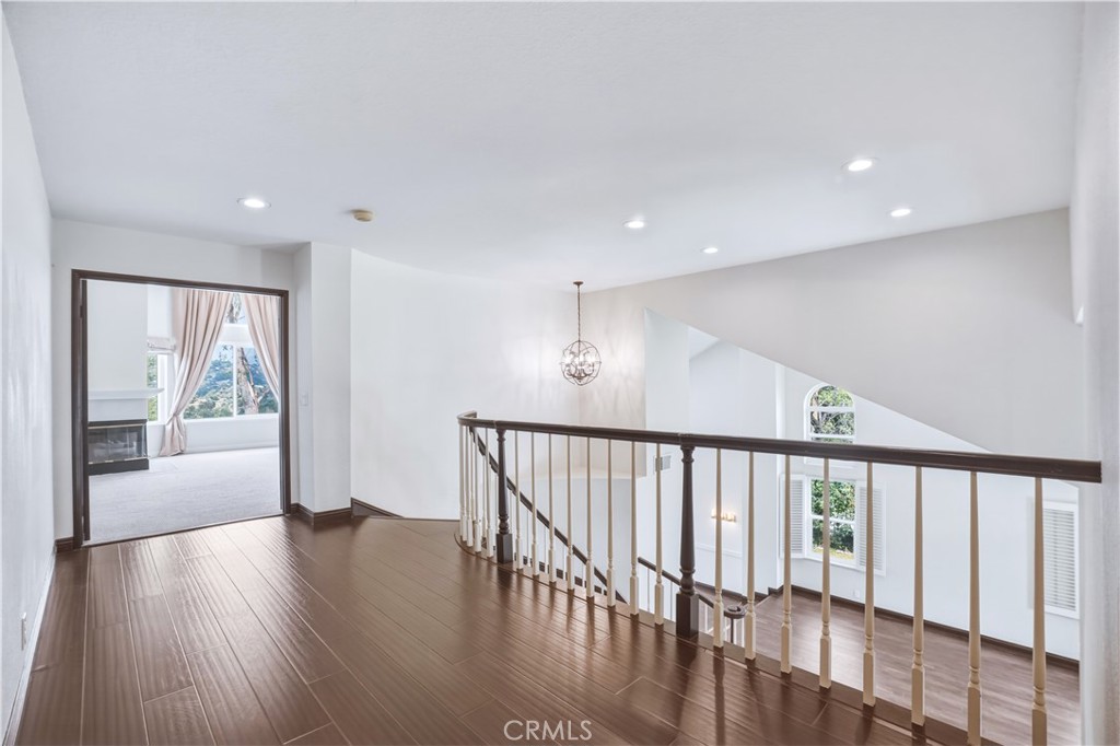 3537 Foxglove Road Glendale, CA 91206 - Photo 56 of 73 a view of a hallway with wooden floor and windows