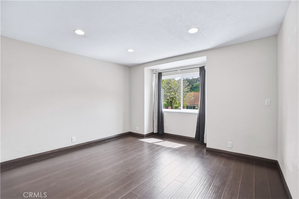3537 Foxglove Road Glendale, CA 91206 - Photo 66 of 73 an empty room with wooden floor and windows