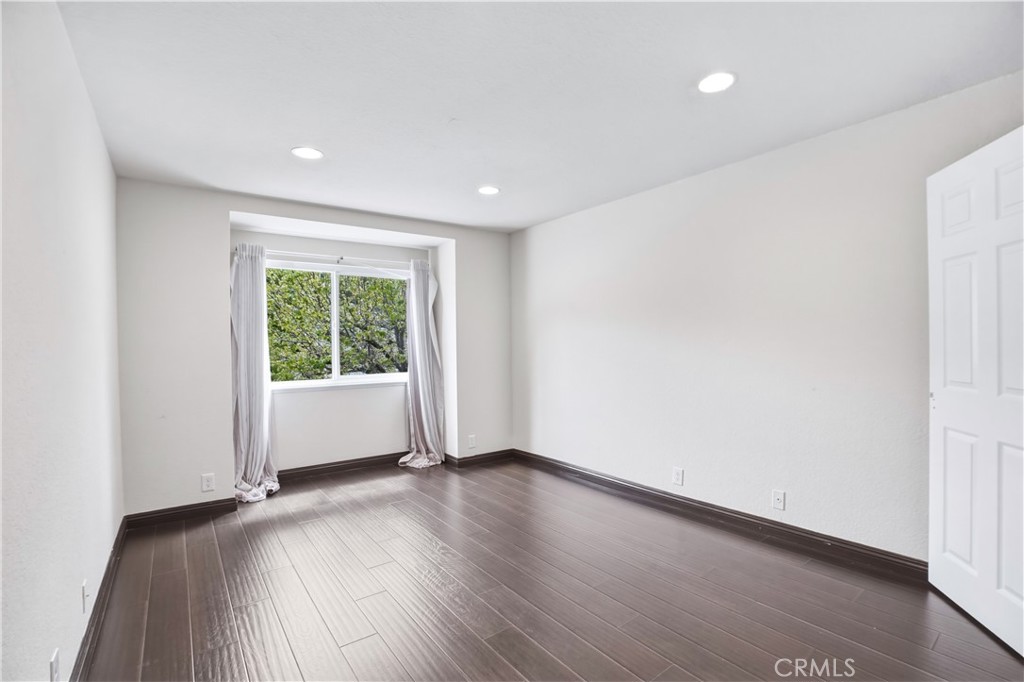 3537 Foxglove Road Glendale, CA 91206 - Photo 68 of 73 a view of an empty room with wooden floor and a window