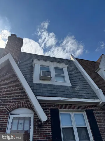 a view of a house with a yard and wooden fence