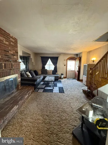 a view of empty room with window and fireplace