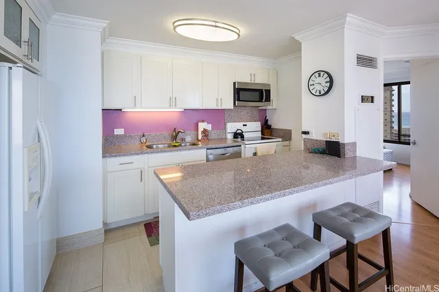 a kitchen with stainless steel appliances granite countertop a sink and a microwave