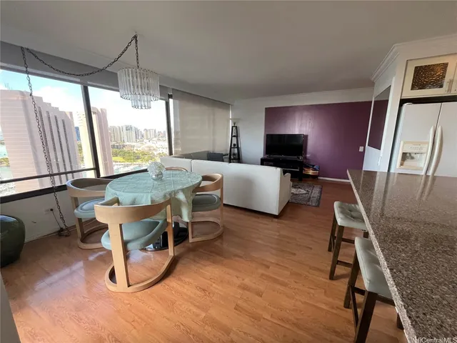 a living room with furniture a window and wooden floor