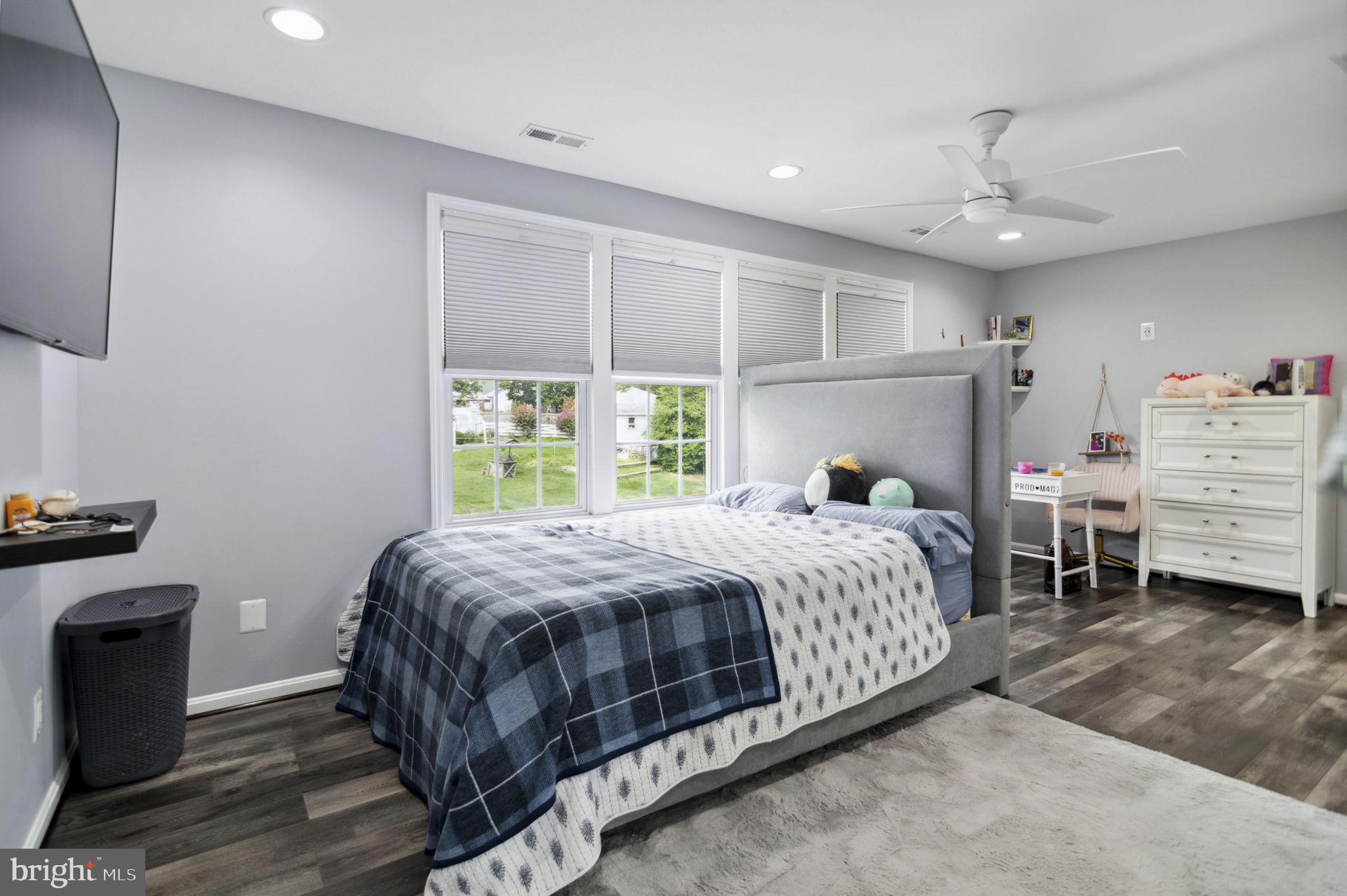 6001 Brandon Avenue Springfield, VA 22150 - Photo 24 of 65 a bedroom with a bed a stove and a window