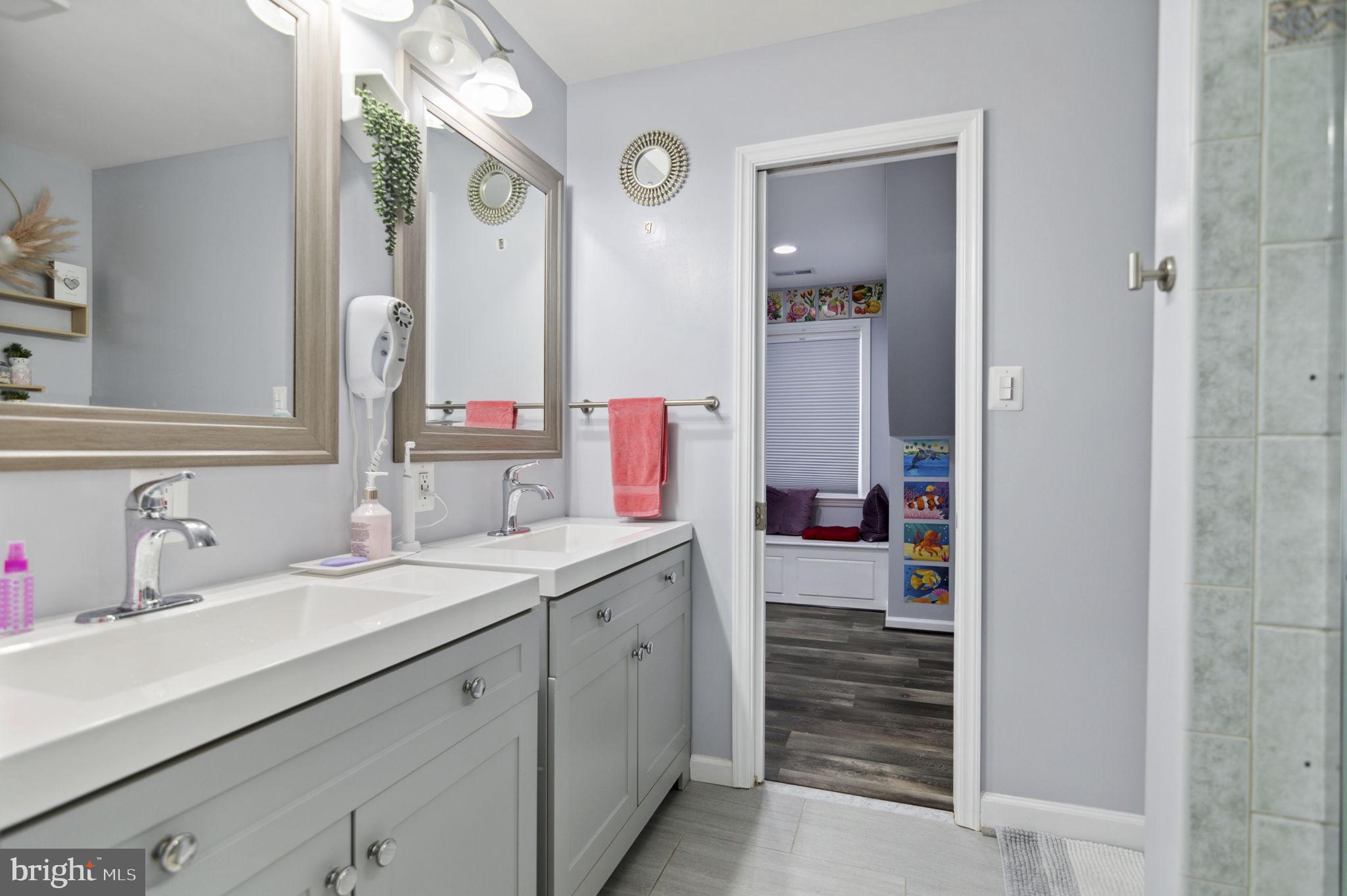 6001 Brandon Avenue Springfield, VA 22150 - Photo 29 of 65 a en suite bathroom with a sink double vanity and a mirror