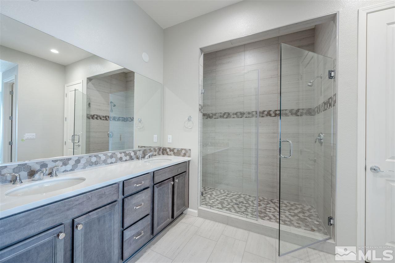 3035 Country Wind Lane, Unit HOMESITE 72 Reno, NV 89521 - Photo 11 of 15 a bathroom with a shower sink vanity and mirror
