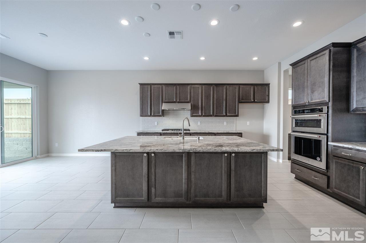 3035 Country Wind Lane, Unit HOMESITE 72 Reno, NV 89521 - Photo 2 of 15 a kitchen with stainless steel appliances granite countertop a sink counter space cabinets and stainless steel appliances