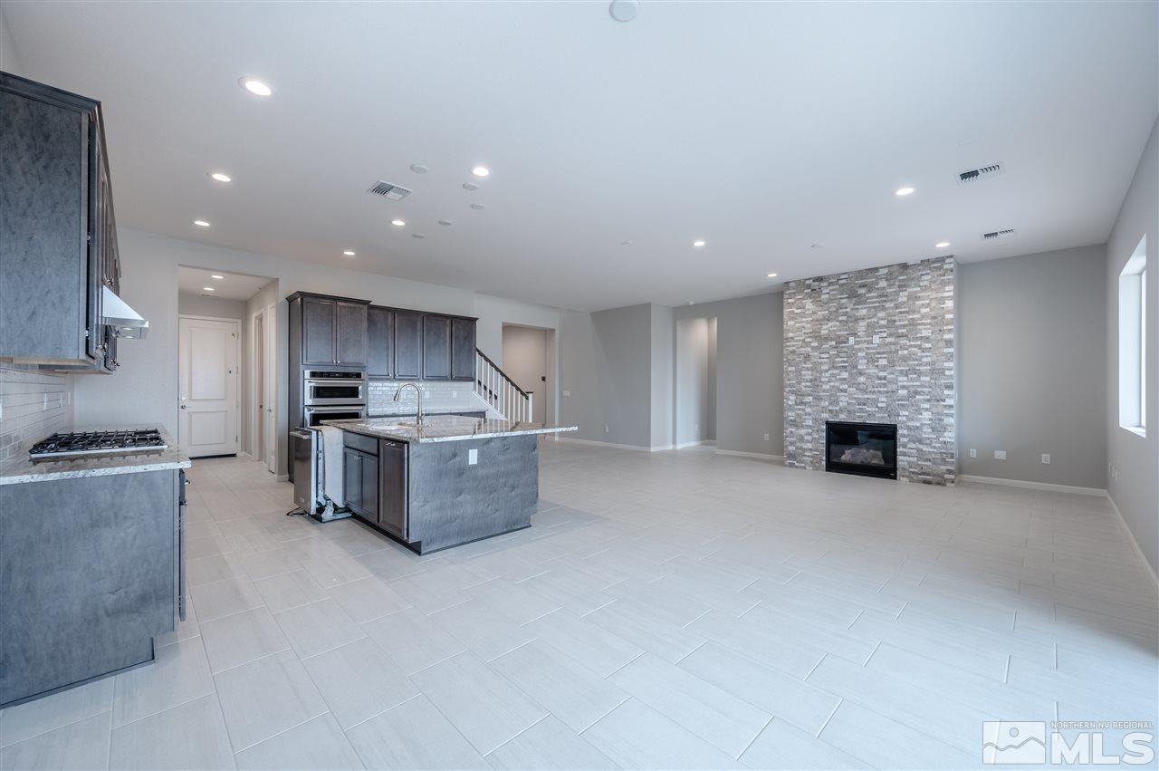 3035 Country Wind Lane, Unit HOMESITE 72 Reno, NV 89521 - Photo 4 of 15 a kitchen with stainless steel appliances kitchen island granite countertop a stove a sink and a refrigerator