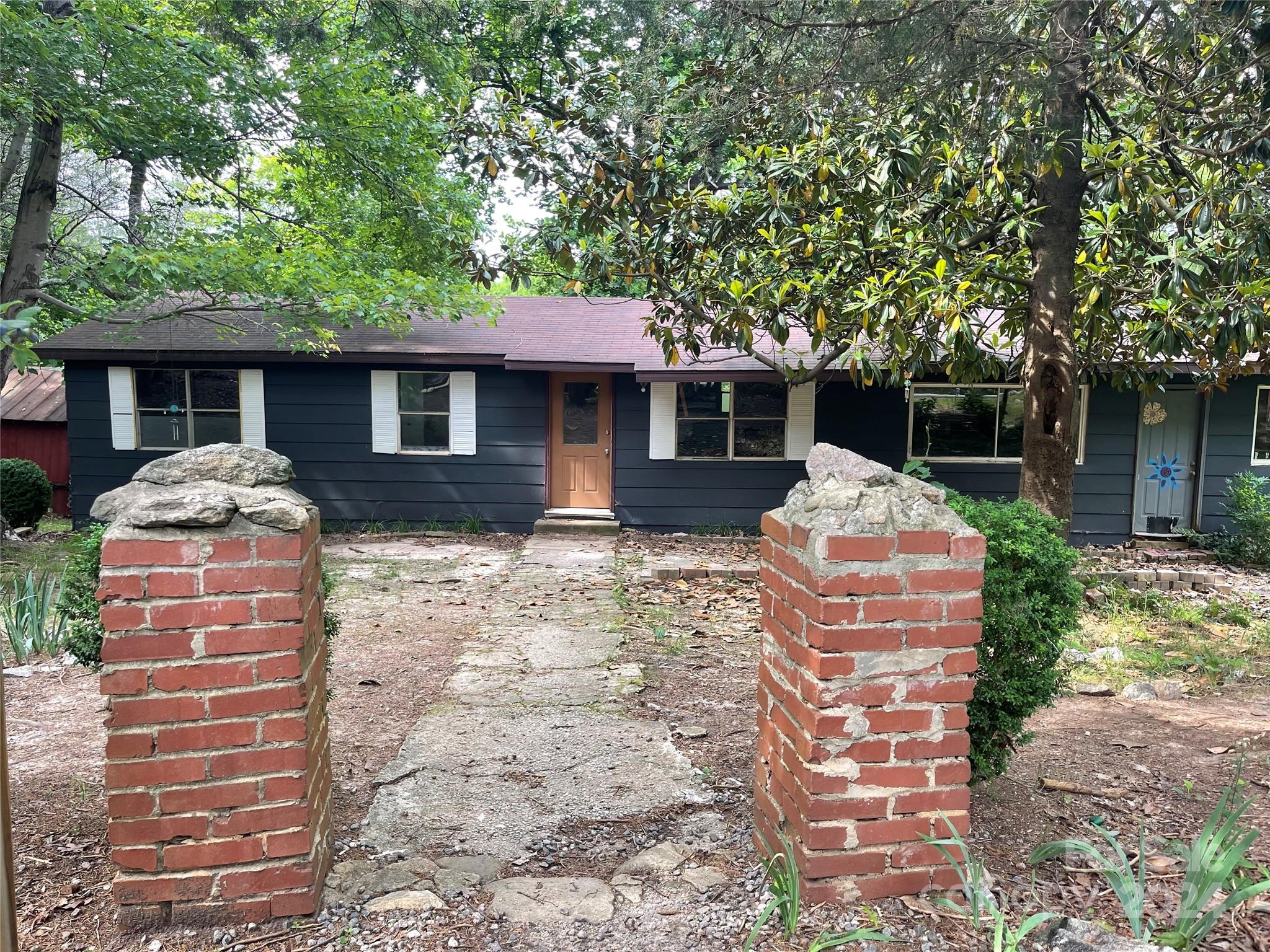 77 Medford Road Tryon, NC 28782 - Photo 2 of 48 a front view of house with yard and trees