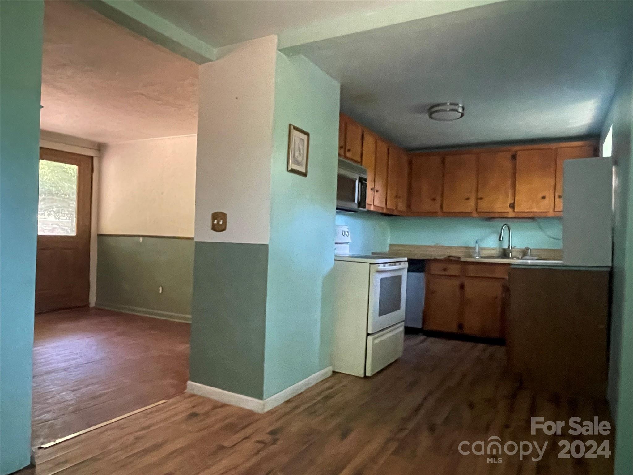 77 Medford Road Tryon, NC 28782 - Photo 28 of 48 a kitchen with a refrigerator and a stove