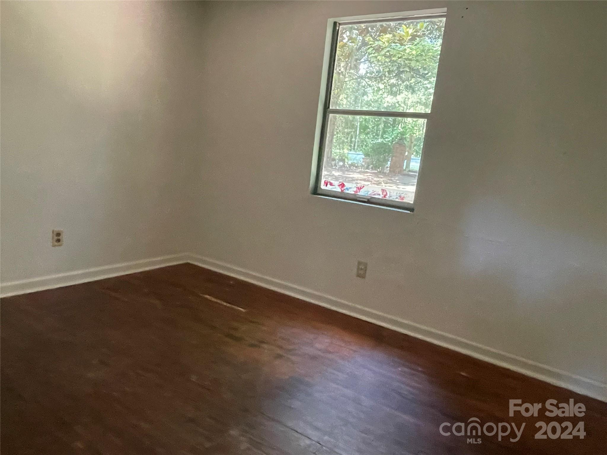 77 Medford Road Tryon, NC 28782 - Photo 33 of 48 an empty room with wooden floor and windows