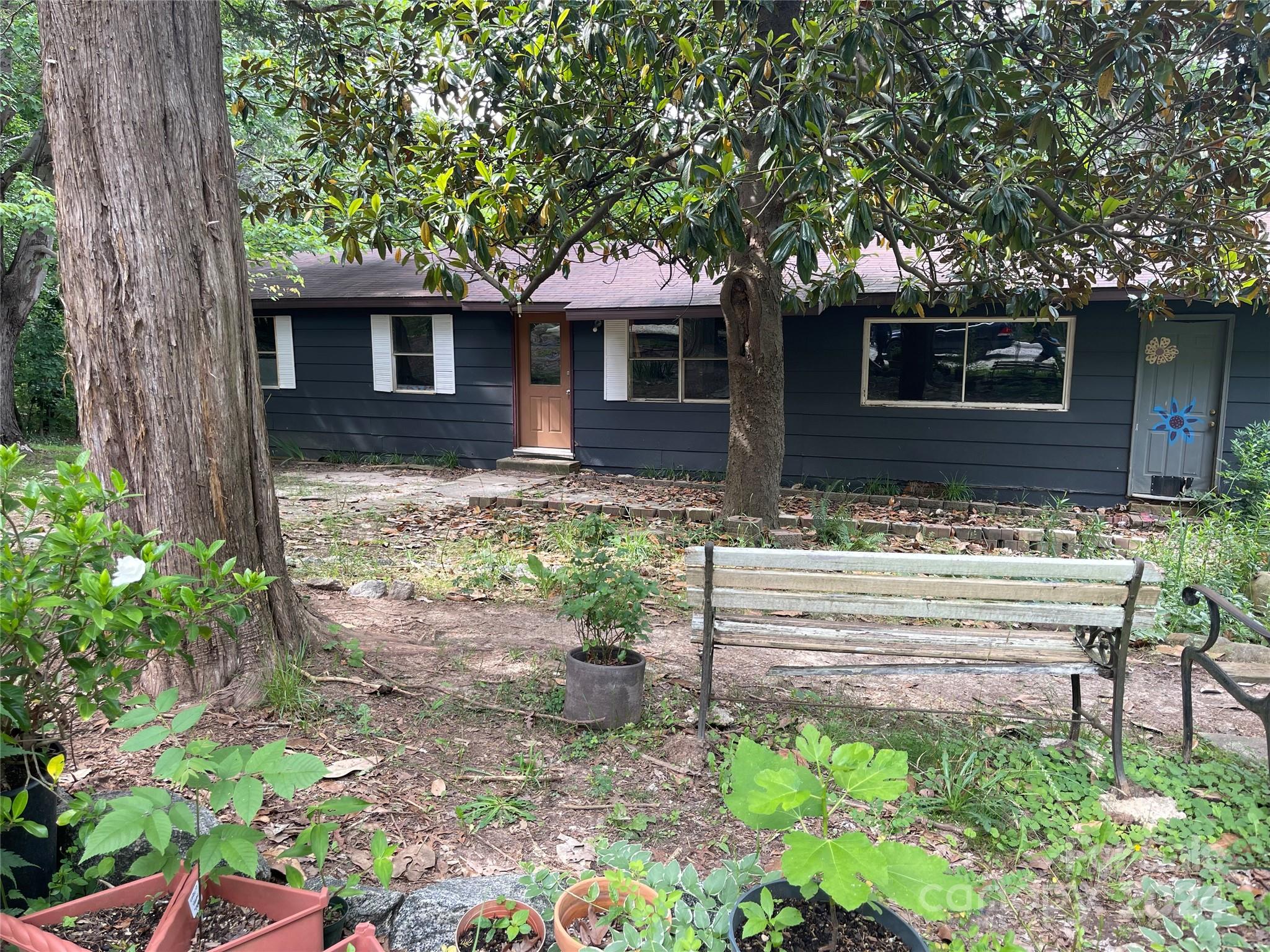 77 Medford Road Tryon, NC 28782 - Photo 4 of 48 a front view of a house with garden