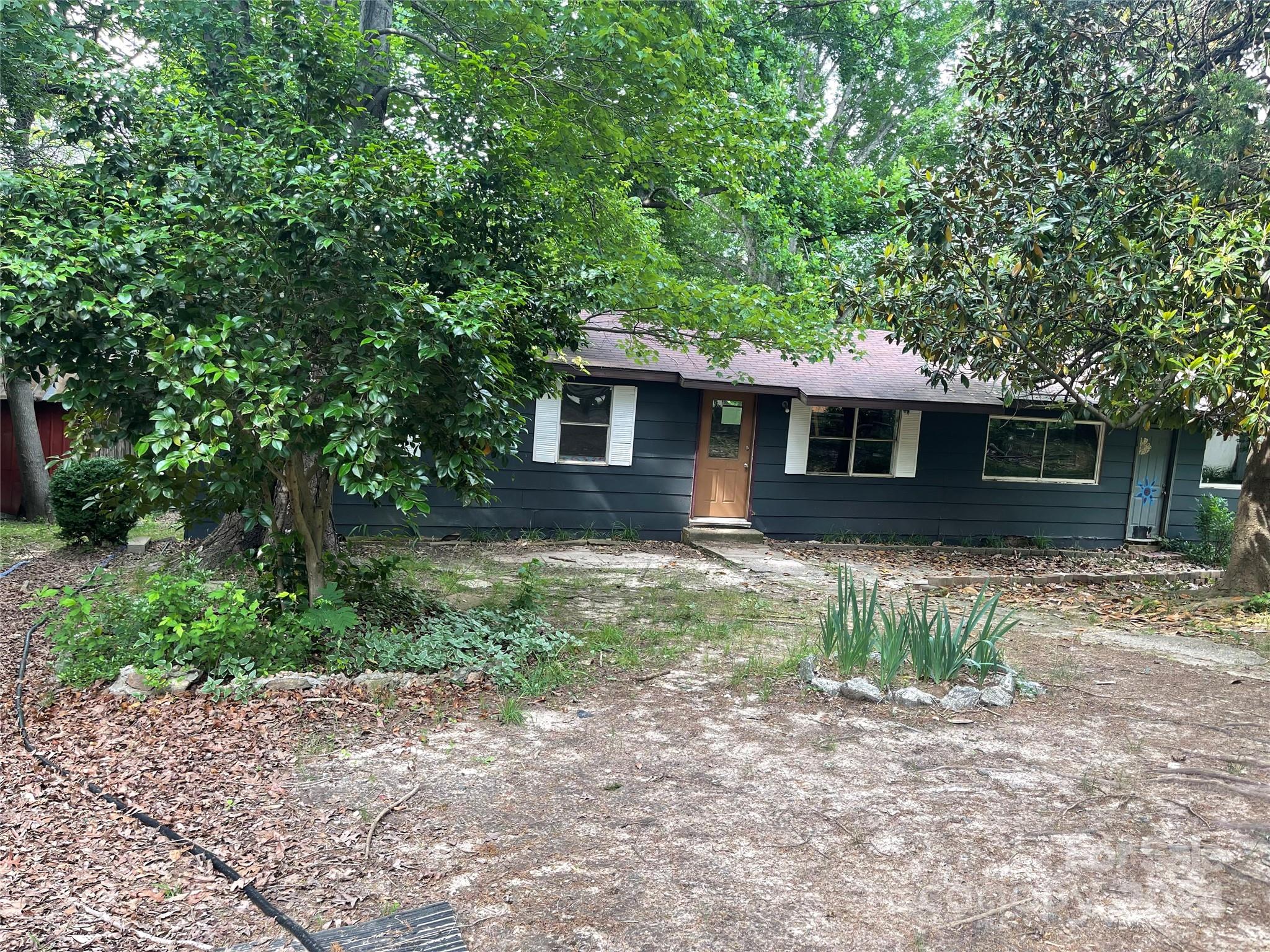 77 Medford Road Tryon, NC 28782 - Photo 5 of 48 a front view of a house with a yard