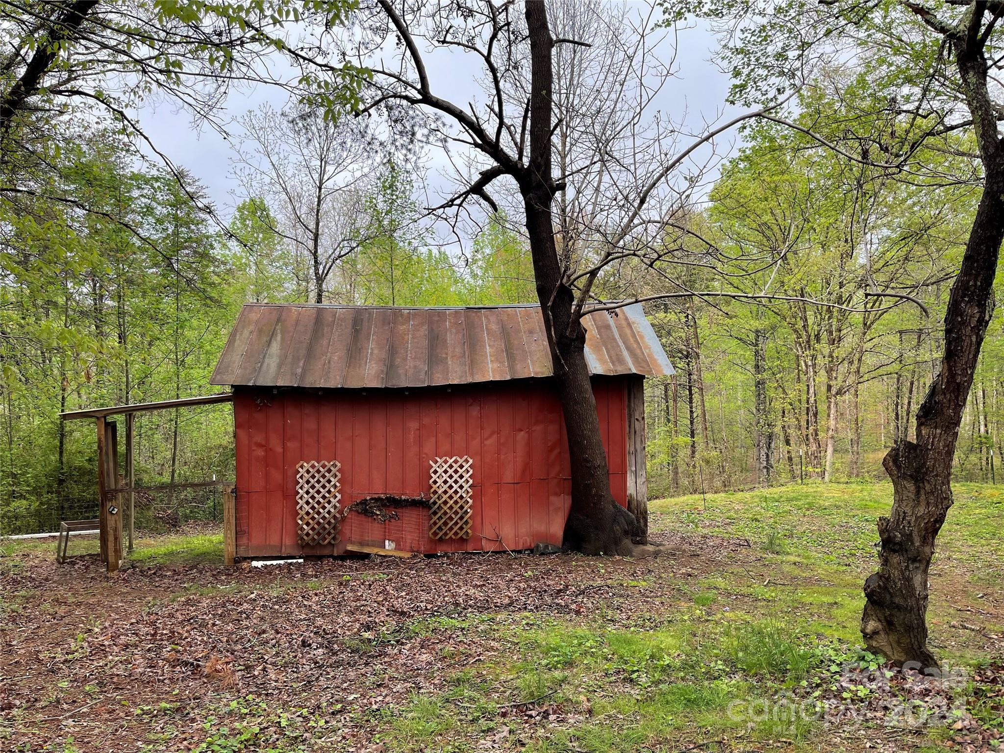 77 Medford Road Tryon, NC 28782 - Photo 8 of 48 a house is sitting in middle of forest