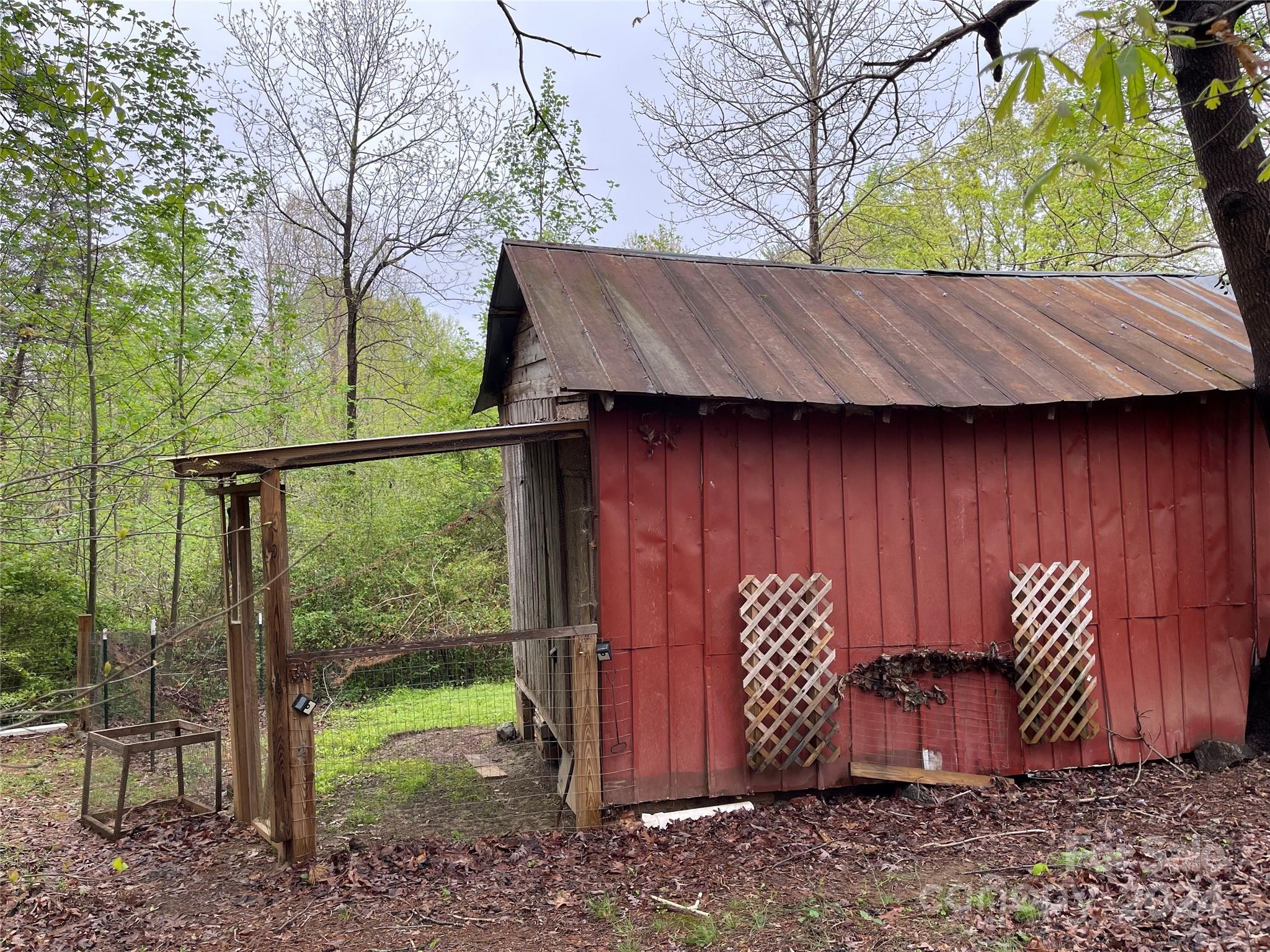 77 Medford Road Tryon, NC 28782 - Photo 9 of 48 a view of a barn in the backyard