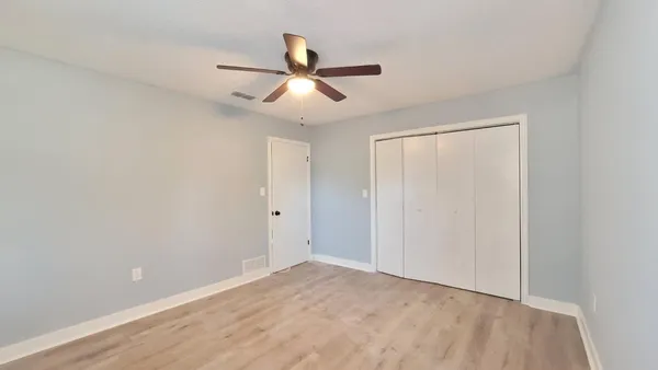 a view of an empty room with wooden floor