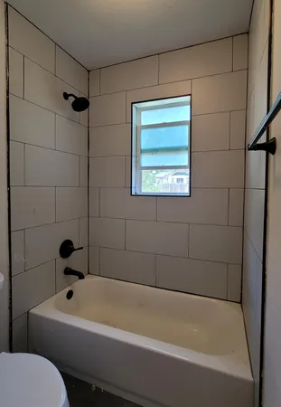 a bathroom with a toilet a sink and bathtub
