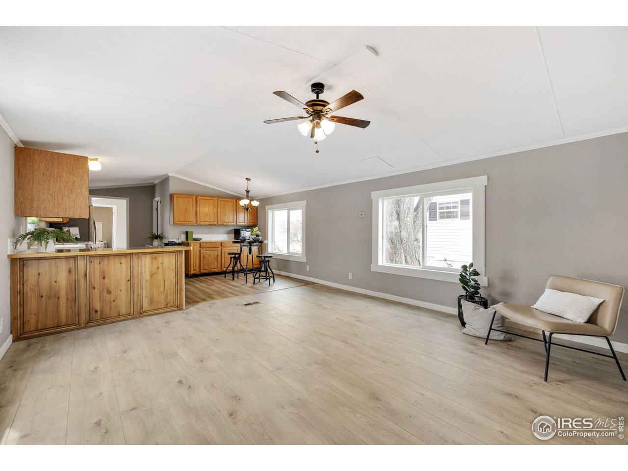 a living room with furniture and kitchen view