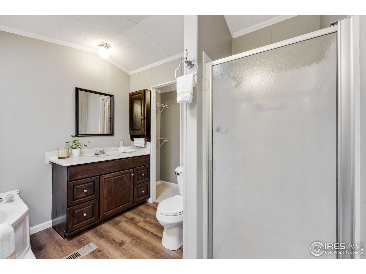 517 East Trilby Road, Unit 102 Fort Collins, CO 80525 - Photo 12 of 19 a bathroom with a sink vanity granite and a mirror