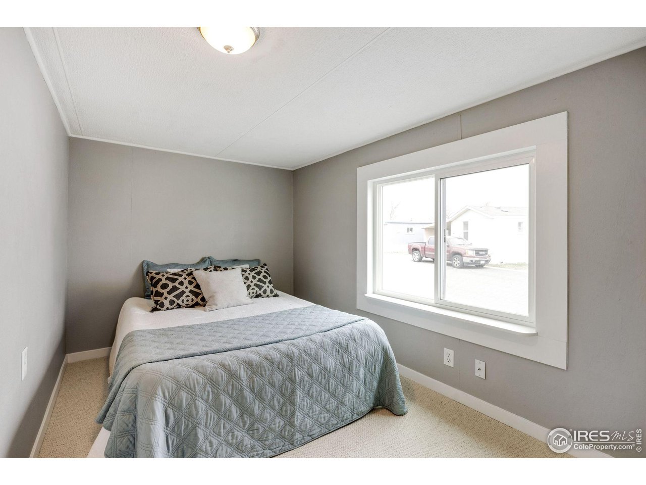 517 East Trilby Road, Unit 102 Fort Collins, CO 80525 - Photo 15 of 19 a bedroom with a bed and a window